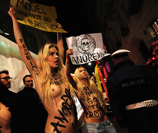 Members of the radical feminist group Femen protest at the entrance of the Versace Fall-winter 2012-2013 show on February 24, 2012 during the Women's fashion week in Milan.    AFP PHOTO / GIUSEPPE CACACE (Photo credit should read GIUSEPPE CACACE/AFP/Getty Images)